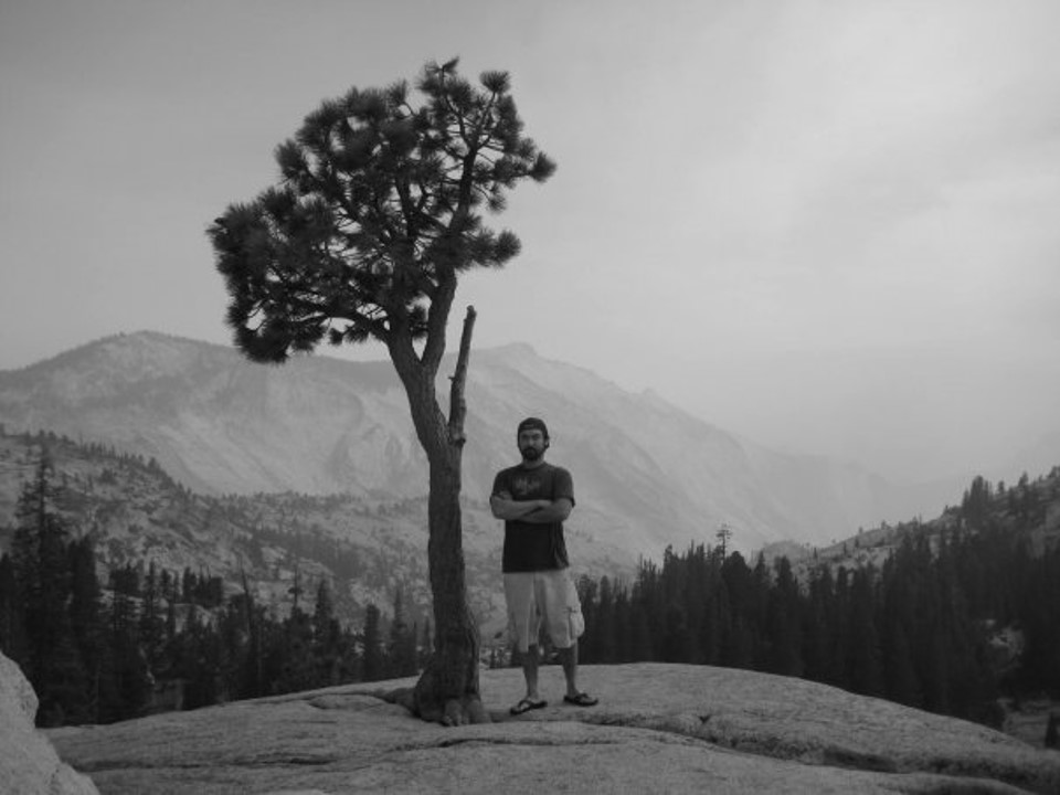 mike next to a tree in the mountains