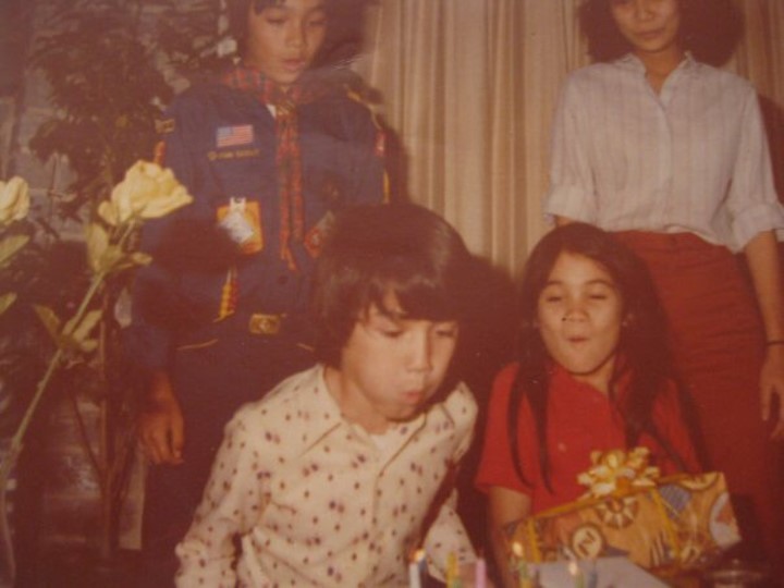 mike blowing out candles with family