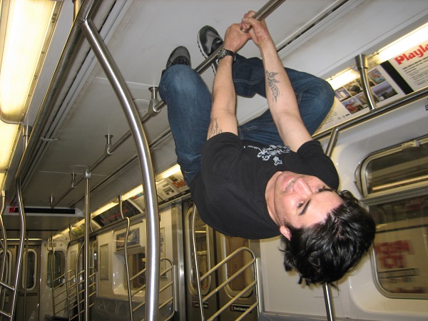 mike hanging upside down in NYC subway